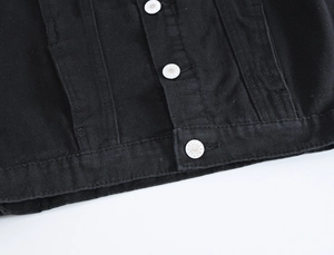 Men's black denim vest detail showing quality fabric and silver JEANS buttons