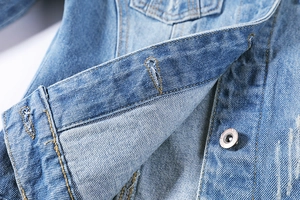 Slim fit light blue denim jacket for women featuring distressed details and metal buttons