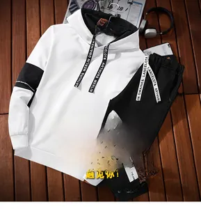 Detailed close-up of a stylish black and white tracksuit with lettered webbing and hood