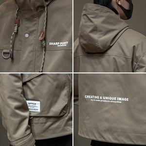 Detailed close-up of hooded techwear jacket featuring windproof nylon and functional pockets