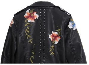 Black faux leather motorcycle jacket with floral embroidery and silver rivets on the back