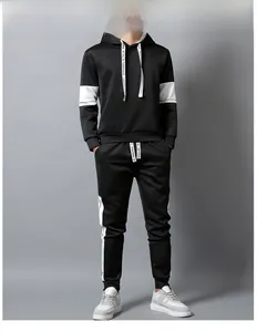 Detail of men's black tracksuit featuring contrast drawstrings and side stripe letter prints