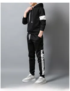 Detail view of black sports hoodie with white patchwork and stylish lettered side tapes