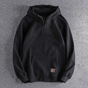 Men's black half-zip hoodie with minimalist leather label and front kangaroo pocket