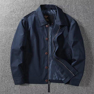 Detail view of navy blue business jacket with metal zipper and dark brown buttons