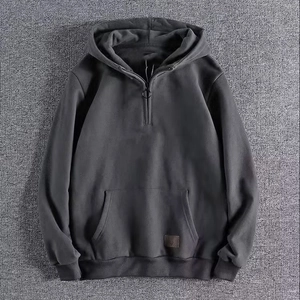 Men's dark grey half-zip hoodie with kangaroo pocket and square leather logo detail