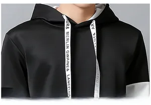 Detailed macro view of black hoodie collar featuring wide white lettered drawstrings