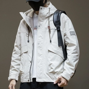 Detail of hooded cargo jacket showing windproof fabric and large utility flap pockets