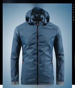 Detail of blue men's waterproof jacket showing zipper pockets and breathable fabric texture