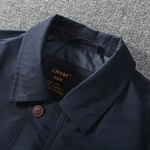 Detail of navy business jacket showing formal collar and branded neck label