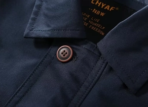 Detail of the navy blue windbreaker jacket collar with high-quality stitching and button