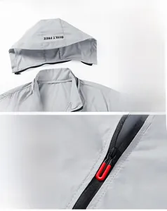 Detail of light gray sun protection jacket with hood and premium zipper with red puller