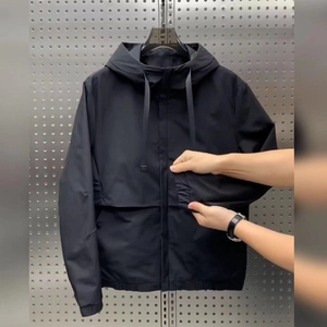 Men's black hooded windbreaker jacket with functional pockets and elastic hem details