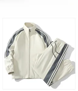 Flat lay of cream casual tracksuit with grey side stripes and classic three-line detail