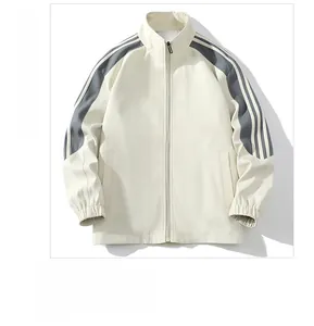 Detailed front view of a beige sports jacket with striped sleeves and elastic cuffs
