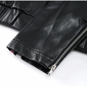 Close-up of black PU leather jacket featuring silver zipper and striped lining detail