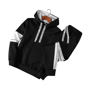 Men's autumn black and white sports tracksuit featuring a hooded jacket and striped joggers