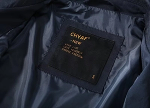 Detail of the golden embroidered brand label and size S on the dark blue jacket lining