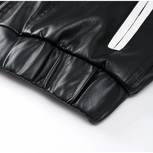 Macro view of black PU leather jacket featuring elastic hem and white side stripes