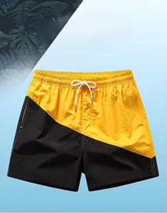 Detail of men's quick-dry swim trunks with black and yellow diagonal contrast design