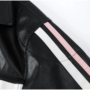 Detail of PU leather biker jacket featuring pink and white stripes on black sleeve