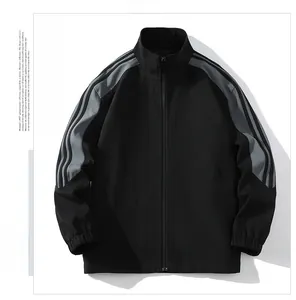 Detail of black sports jacket featuring a stand collar and striped contrast sleeves