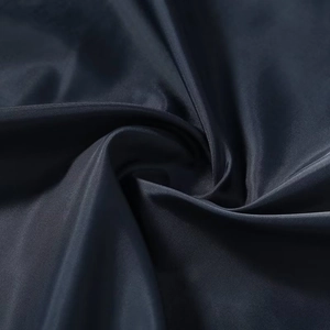 Macro shot of dark blue business jacket fabric showing high quality texture and silky sheen