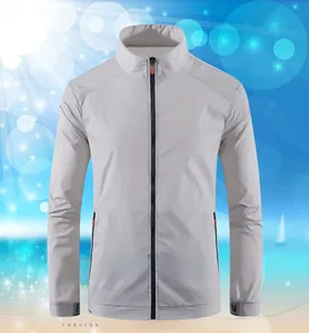 Detail of light gray sun protection jacket with orange zip pullers and stand collar