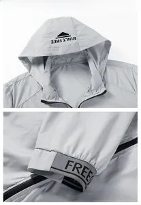 Detail view of light gray sun protection jacket with adjustable hood and elastic cuffs