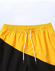 Detail of elastic waist with drawstring on men's quick-dry yellow and black beach shorts