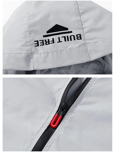 Detail of grey sun protection jacket with BUILT FREE hood logo and red U-shaped zipper puller
