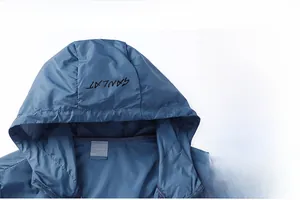 Detail view of water-resistant fabric and printed hood on men's blue sun protection jacket