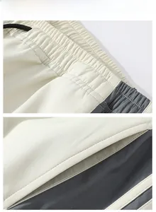 Detail of casual sport pants featuring elastic drawstring waist and bicolor side pockets