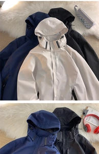 Detail of hooded techwear jacket with EXPLORE print and adjustable drawstring closure