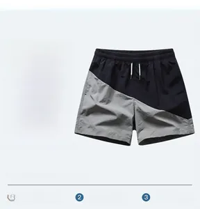 Detail of men's quick-dry beach shorts featuring gray-black panels and drawstring waist