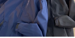 Detail of waterproof zippers and adjustable velcro cuffs on tactical outdoor jackets