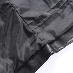 Close-up of black PU leather texture and smooth lining on men's slim fit biker vest