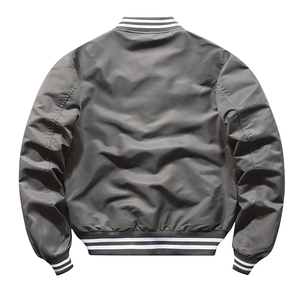 Detail of grey baseball jacket showing black and white striped ribbed cuffs and hemline