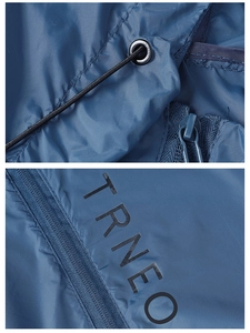 Detail of the metal drawstring eyelets, zipper puller, and lettering on the blue sun jacket