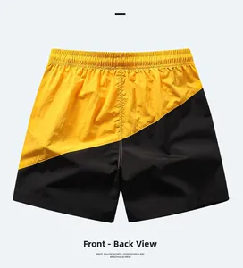 Detail view of quick-dry men's board shorts with yellow and black contrast stitching