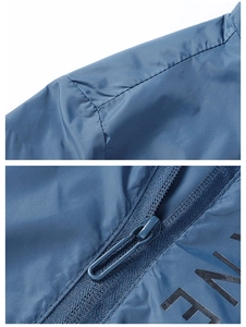 Detail of navy blue sun protection jacket showing reinforced seams and resin zipper