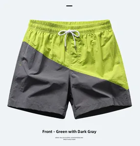 Detail of men's quick-dry beach shorts featuring neon green and dark grey contrast panels