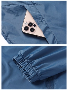 Detail view of the blue sun protection jacket featuring elastic cuffs and a side pocket