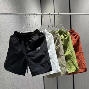 Detail showing various colors of quick-dry shorts with drawstring waist and stitched seams