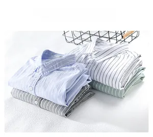 Detail showing stacked vertical striped cotton shirts in light blue, white, and grey