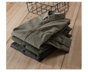 Detailed stack of long-sleeve men's shirts in olive green, dark green, and black colors