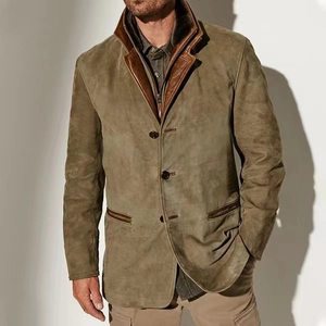 Macro detail of men's vintage olive jacket with brown leather trim and fabric texture