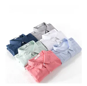 Flat lay of cotton linen shirts in multiple colors featuring collars and size labels