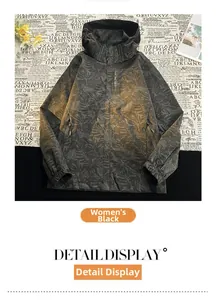 Dettaglio della giacca a vento con cappuccio, logo explore e stampa mimetica foglia