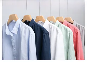 Detailed row of men's cotton linen long sleeve shirts in various pastel colors on hangers